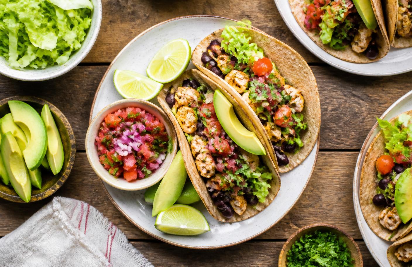 Healthy family tacos with chicken, black beans, avocado, and fresh salsa
